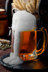 Light foam beer in a glass on an old background