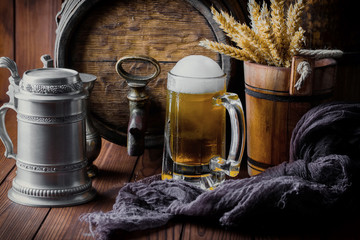 Light foam beer in a glass on an old background