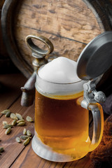 Light foam beer in a glass on an old background