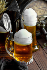 Light foam beer in a glass on an old background