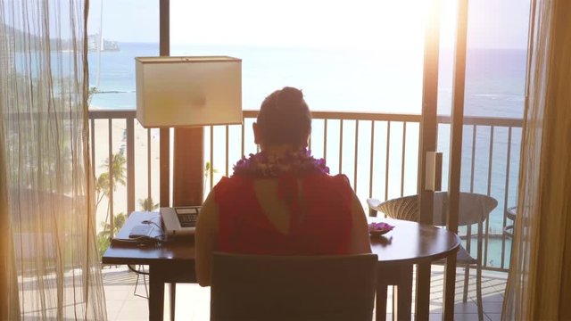 Professional video of woman working in paradise office in 4k slow motion 60fps