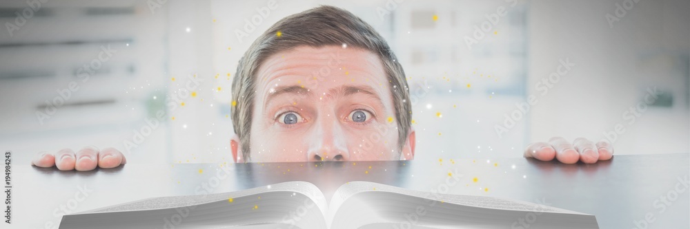 Poster man looking at an opened book with lights on a table