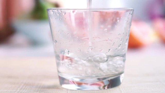 Filling water glass in slow motion