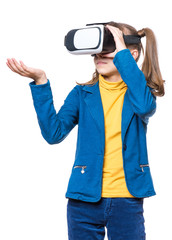 Happy little girl wearing virtual reality goggles watching movies or playing video games. Cheerful smiling teenager looking in VR glasses. Funny child experiencing 3D gadget technology - close up.