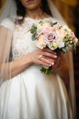 wedding bouquet in hands of bride