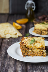 Homemade meat lasagna on wooden table