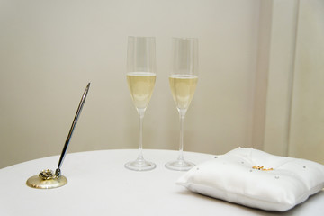 glasses, rings and other attributes on the wedding table for the wedding ceremony