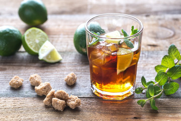 Glass of rum on the wooden background