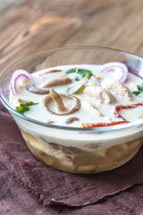 Glass bowl of thai tom kha kai soup