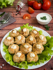 Delicious meatballs with parsley, lettuce and tomato closeup on a plate on the table. vertical