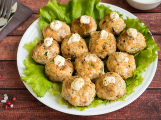 Delicious meatballs with parsley, lettuce and tomato closeup on a plate on the table. horizontal