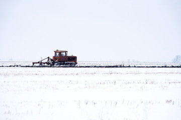 Crawler Tractor plowing field.
