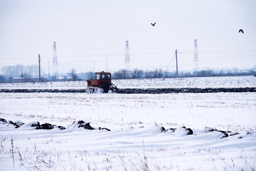 Crawler Tractor plowing field.