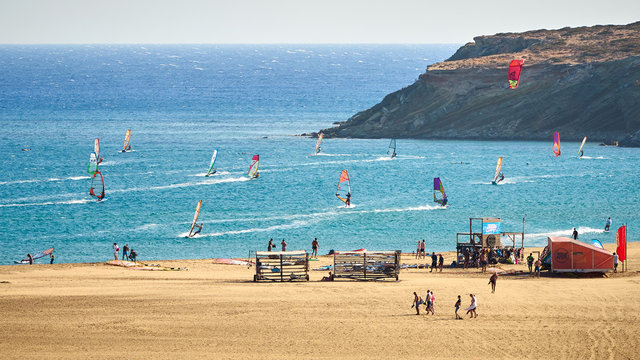 Windsurfers and kitesurfers riding at the Prasonisi kite beach at Rhodes island