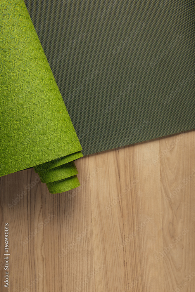 Canvas Prints top view of green yoga mat on wooden brown floor