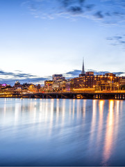 Stockholm sunset skyline with City Hall as seen from Riddarholmen.