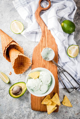 Mexican food, homemade organic lime and avocado ice cream, with ice cream cones, slices of sweet tortilla. On a grey stone table, copy space
