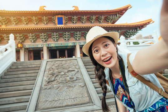 Happy Asian tourist taking a fun selfie