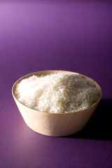 Bowl of rice against a purple background