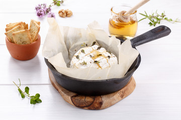 Baked camembert cheese with thyme and pepper