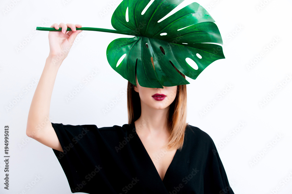 Sticker beautiful woman in dark clothes with palm leaf