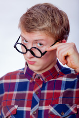 Young nerd teen boy with round glasses