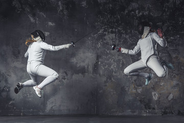 Fototapeta na wymiar Two women fencing