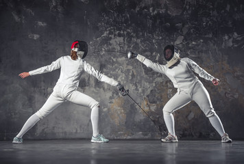 Two women fencing