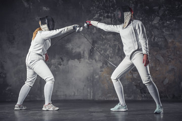 Two women fencing