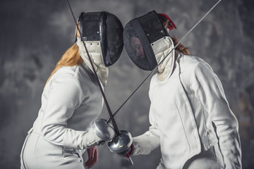 Two women fencing