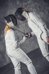 Two women fencing