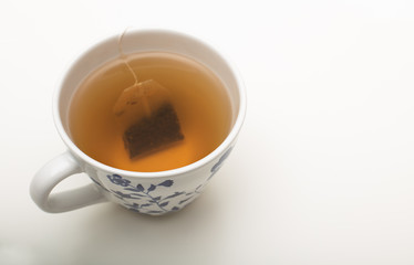 Teabag steeping in boiling water in a teacup