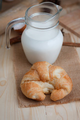 Croissant on wooden table wood and fabric select focus shallow depth of field