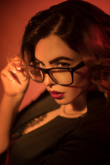 Fototapeta na wymiar Sexy young secretary in glasses and red lips