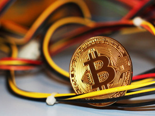 Golden Bitcoin virtual currency, colored electrical wires