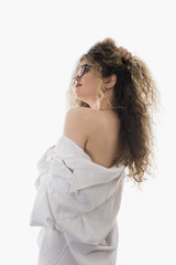 Woman with curly hair and white shirt posing on white background