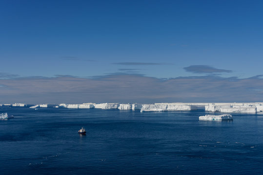 Antarctic landscape with expedition ship aerial view