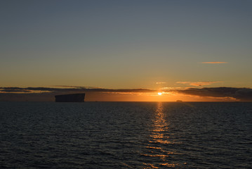 Tabular iceberg at sunset