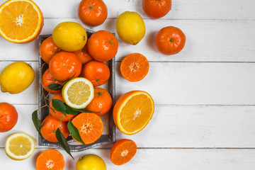 Fresh citrus fruits background flat lay, healthy lifestyle vegetarian organic antioxidant detox diet beverage. Tropical summer assortment grapefruit, orange, lemon,tangerines