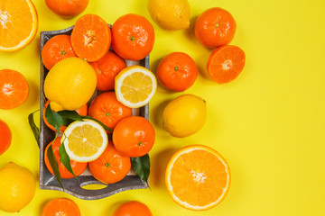 Fresh citrus fruits background flat lay, healthy lifestyle vegetarian organic antioxidant detox diet beverage. Tropical summer assortment grapefruit, orange, lemon,tangerines