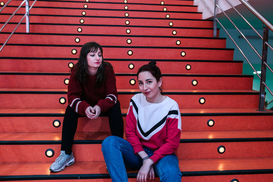 girlfriends sitting on stairs talking