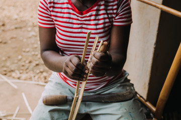 person working with bamboo in Rwanda, Africa