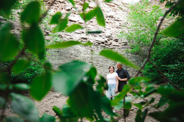 Active loving senior couple walking in beautiful summer forest - active retirement concept