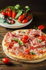 Italian pizza with mozzarella, tomato and bacon