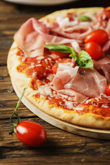 Italian pizza with mozzarella, tomato and bacon