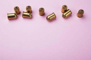 Training bullets on a pink background, top view. Copy space.