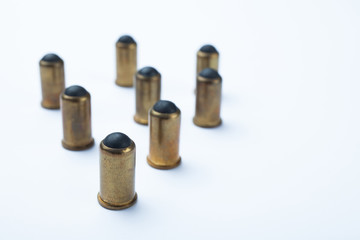 Old rubber bullets on a white background, selective focus.