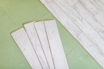 Naklejka na ściany i meble Wooden panels on new laminated flooring before install
