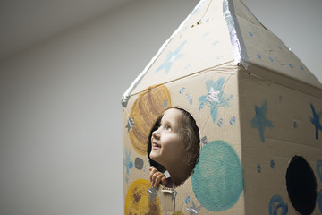 Little astronaut ready to travel to the stars. Playing with spaceship