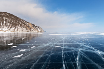 Baikal Lake in the winter. A minimalistic landscape with endless expanses of blue smooth ice